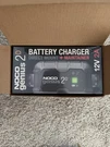 Noco GENIUS2D Direct-mount 6V/12V 2-AMP Smart Battery Charger. Fixed Price $49.00.